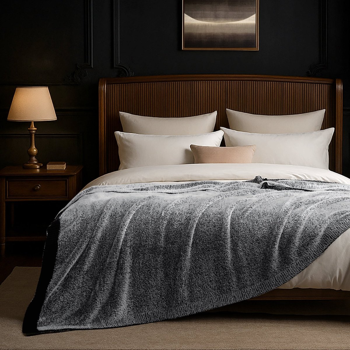 Faux Mink Feather Knit Throw Blanket in Black draped over a bed in a dim bedroom setting, creating a warm and relaxing atmosphere. #color_Black