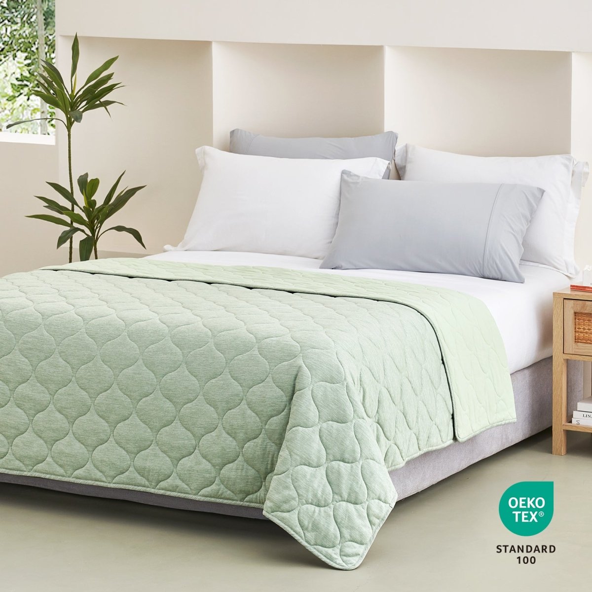 Sage green Cozy Bliss cooling blanket on a bed #color_Sage Green
