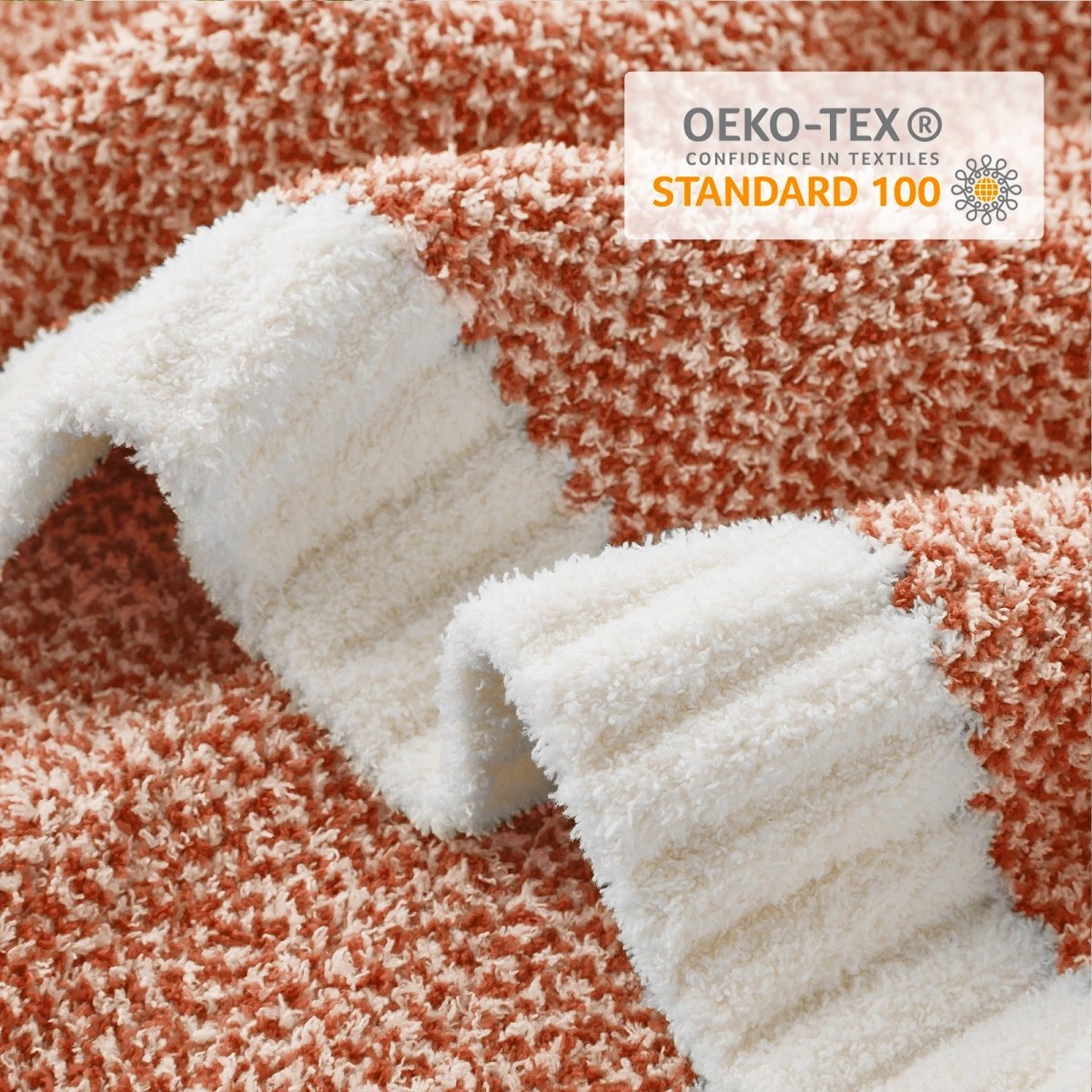 Close-up of Heather Feather Yarn Throw Blanket in Orange showcasing plush texture and OEKO-TEX STANDARD 100 certification. #color_Orange