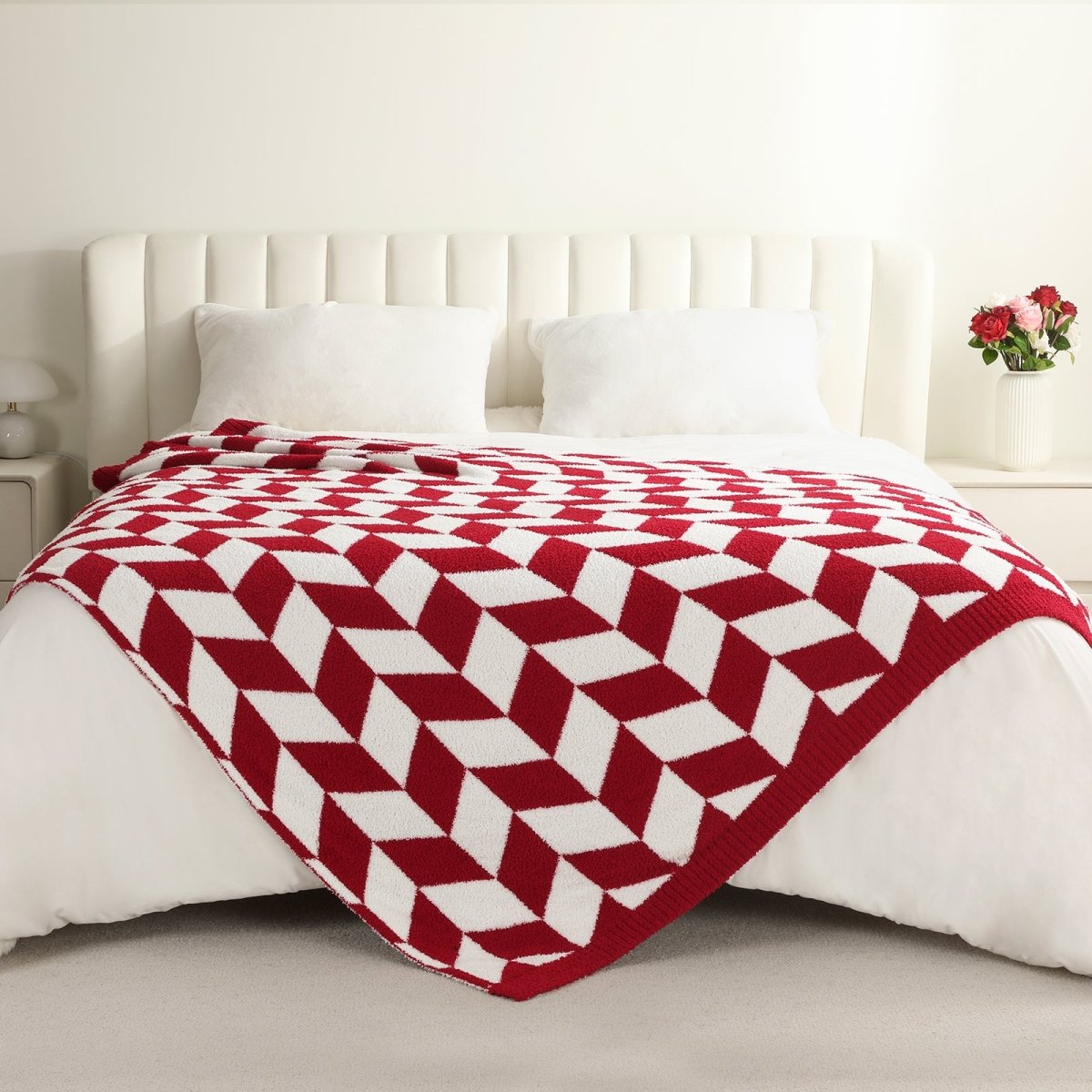Chevron Feather Yarn Knit Throw Blanket in Red styled on a bed, highlighting soft texture and modern chevron pattern in a bright bedroom setting. #color_Christmas Red
