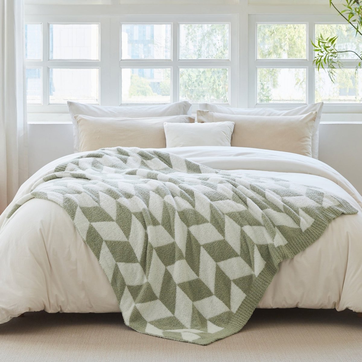 Chevron Feather Yarn Knit Throw Blanket in Sage Green styled on a bed, highlighting soft texture and modern chevron pattern in a bright bedroom setting. #color_Sage Green