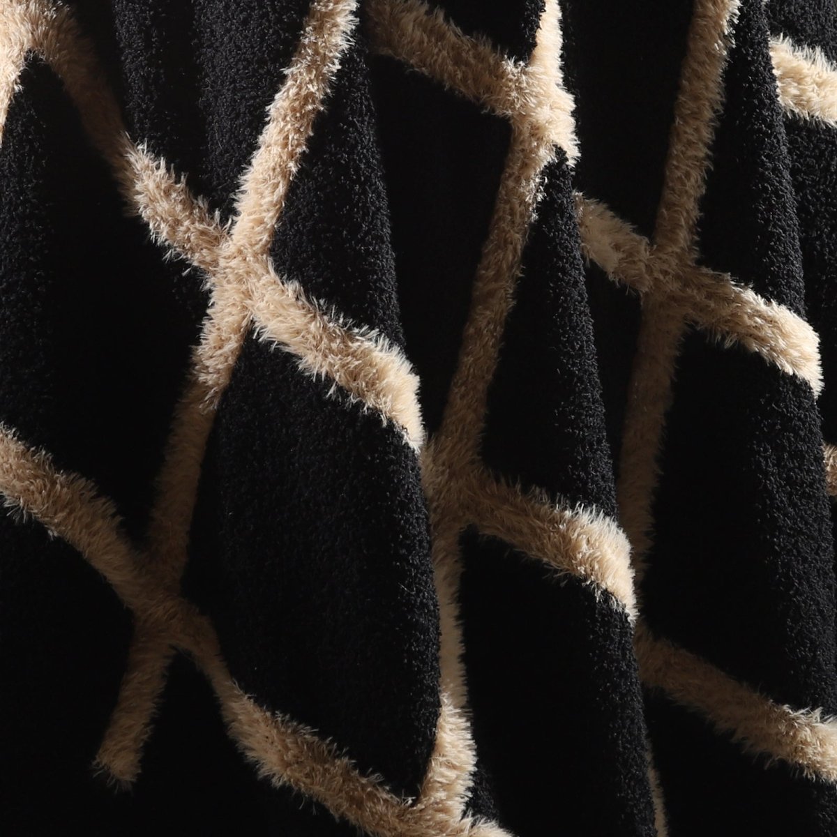 Close-up of faux mink fibers on Faux Mink Textured Plaid Knit Throw Blanket in Black highlighting ultra soft and fluffy texture detail. #color_Black
