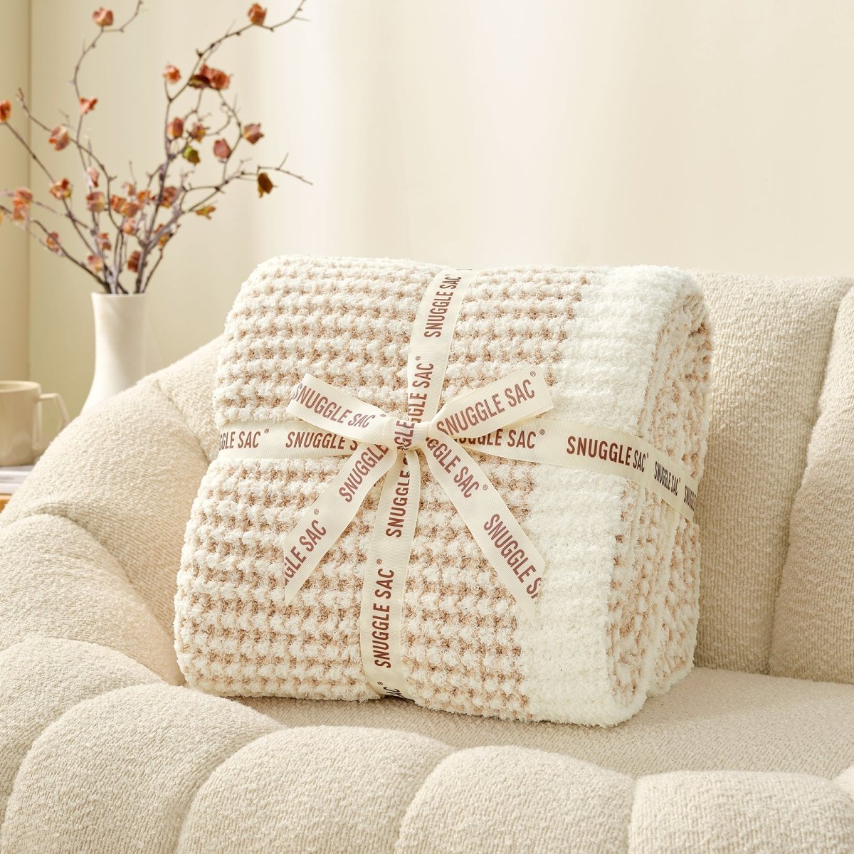 Soft Waffle Feather Yarn Throw Blanket in Cream/Beige neatly folded as gift packaging, perfect for home decor and gifting. #color_Cream/Beige