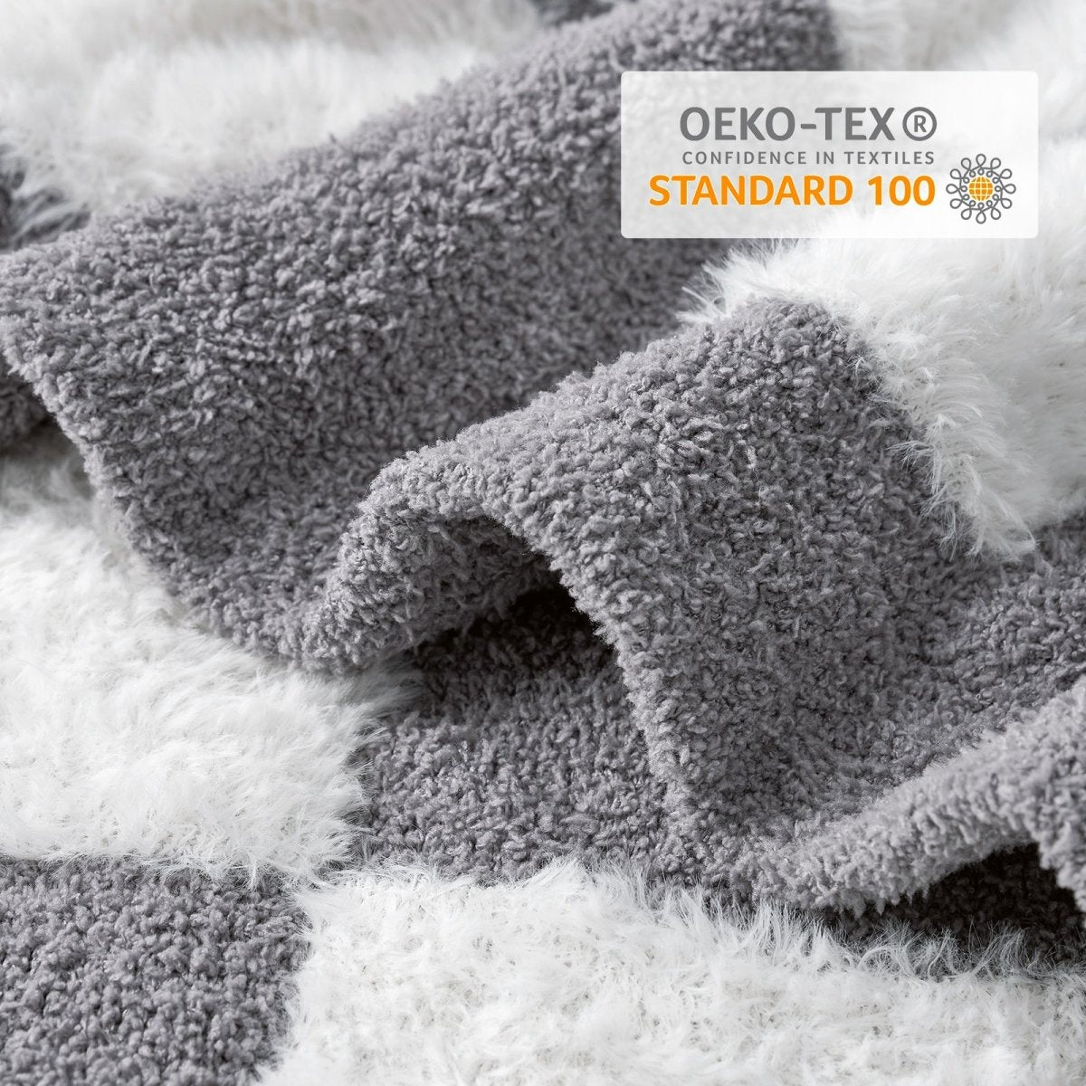 Close-up of Checkered Faux Fur Feather Yarn Throw Blanket in Grey & White showcasing plush texture and OEKO-TEX STANDARD 100 certification. #color_Grey & White