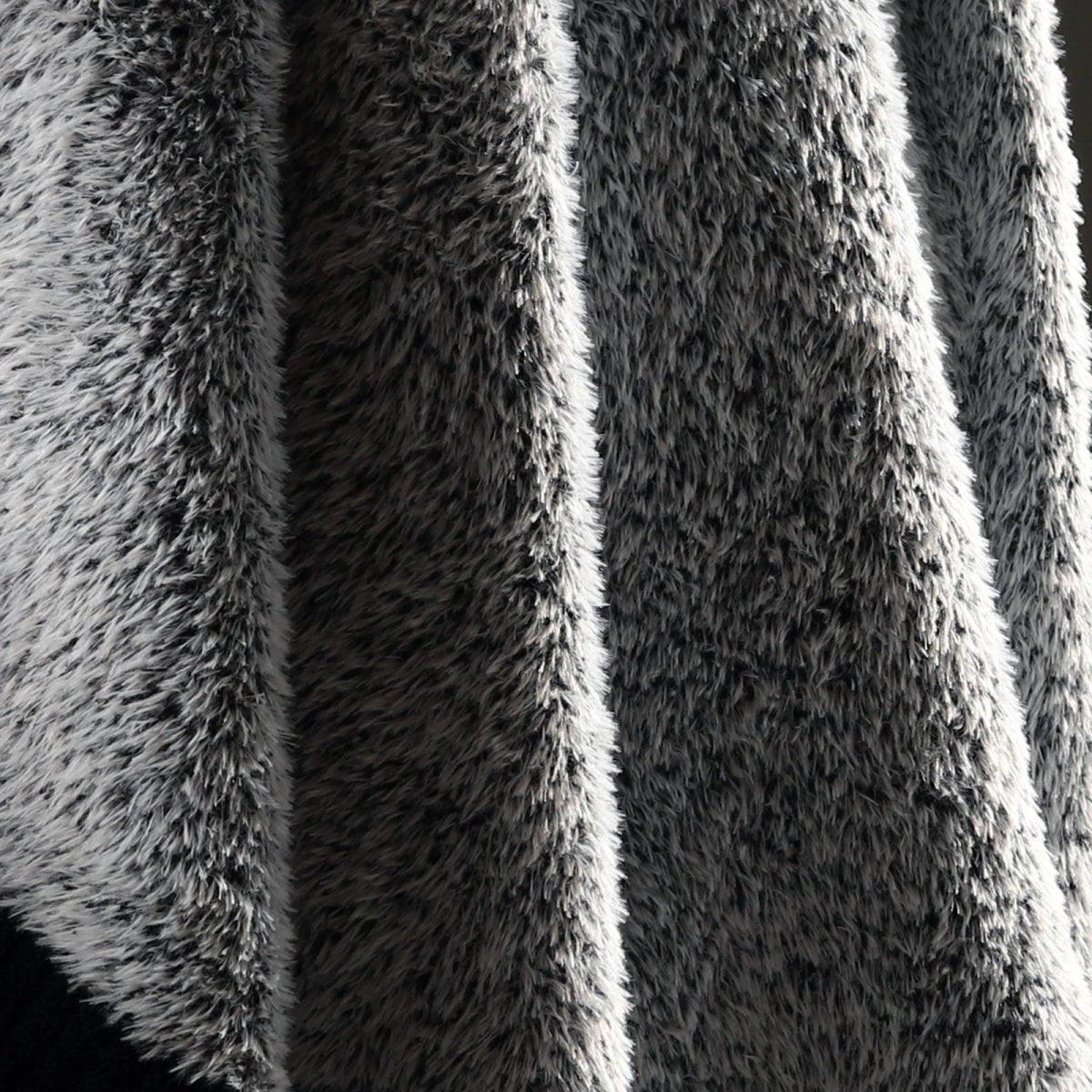 Macro close-up of faux mink fibers on Faux Mink Feather Knit Throw Blanket in Black showcasing ultra soft and fluffy texture detail. #color_Black