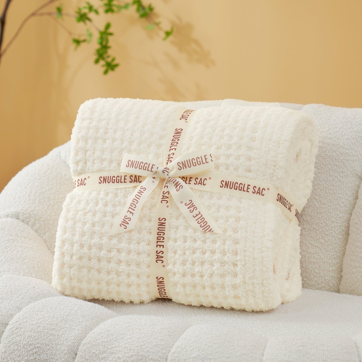 Soft Waffle Feather Yarn Throw Blanket in Cream White neatly folded as gift packaging, perfect for holidays and special occasions. #color_Cream White