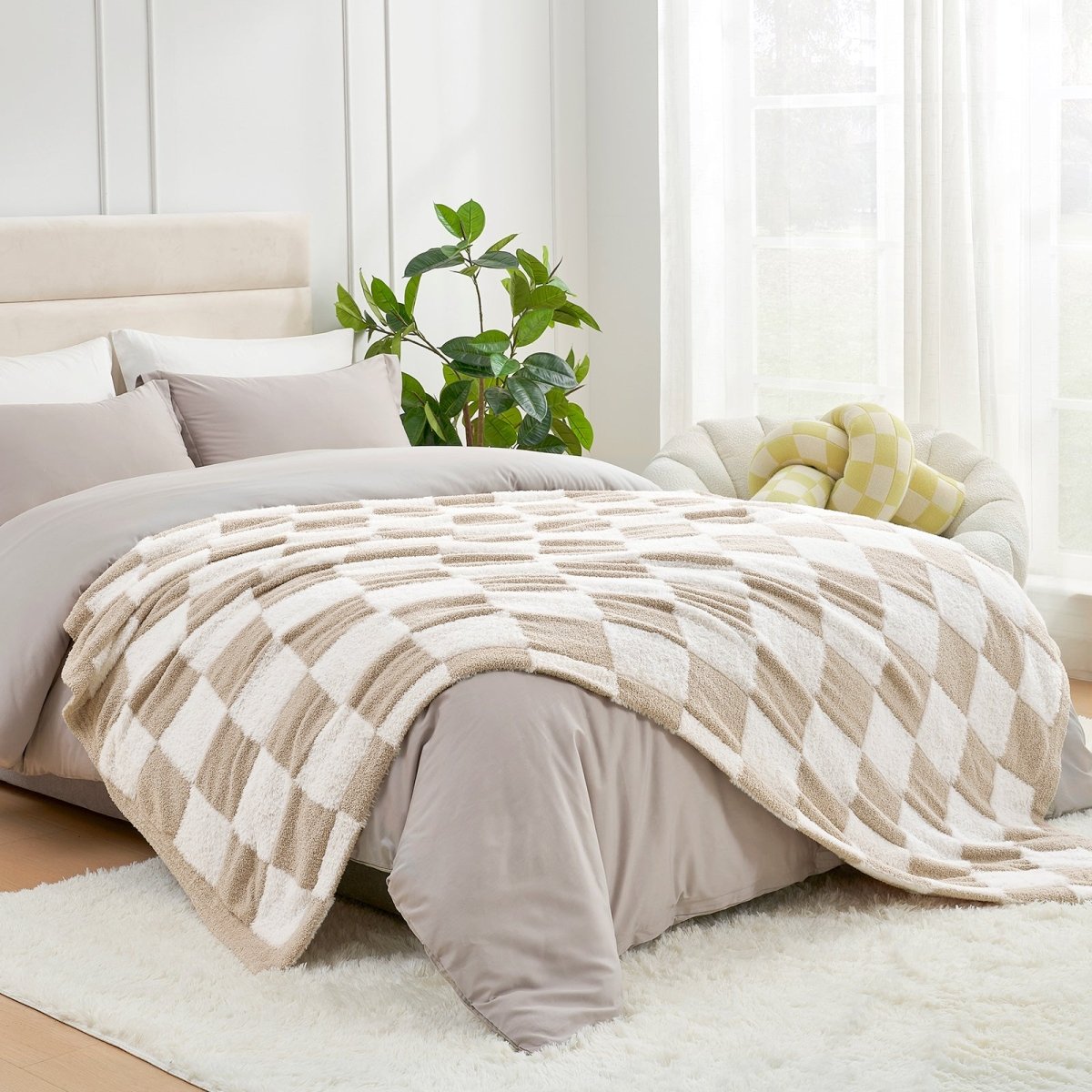 Checkered Faux Fur Feather Yarn Throw Blanket in Beige & White styled on a bed, adding a cozy and elegant layered look. #color_Beige & White