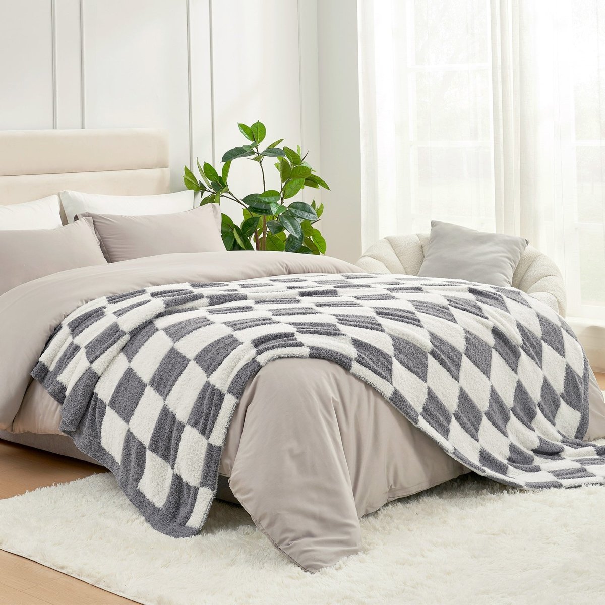 Checkered Faux Fur Feather Yarn Throw Blanket in Grey & White styled on a bed, adding a cozy touch. #color_Grey & White