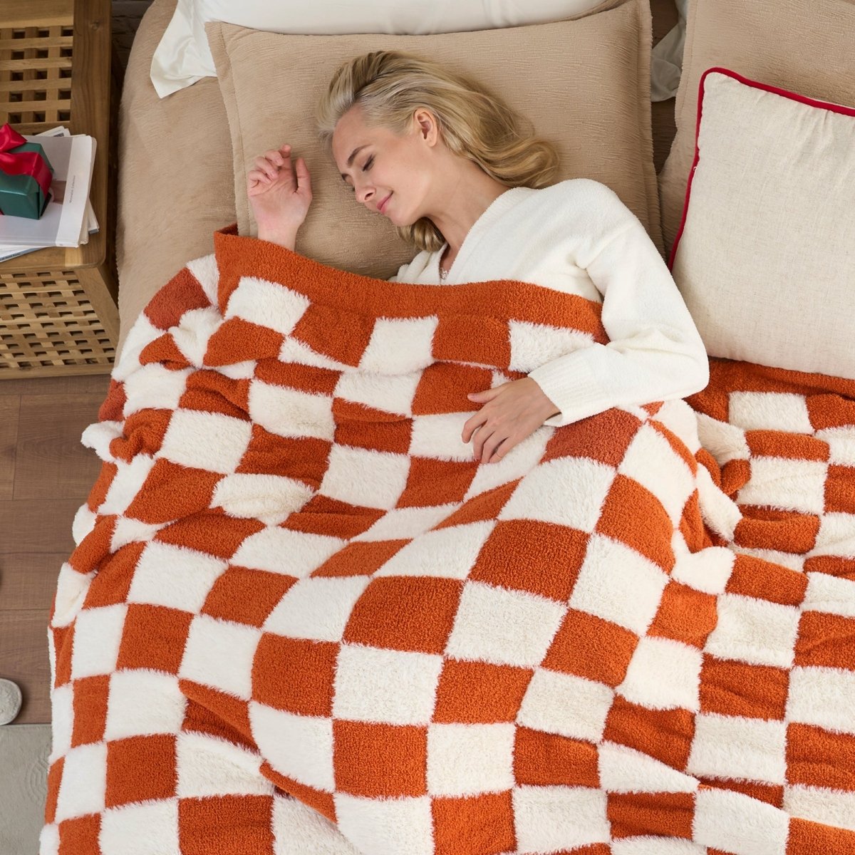 Woman sleeping under a Checkered Faux Fur Feather Yarn Throw Blanket in Orange, offering warmth and comfort. #color_Orange