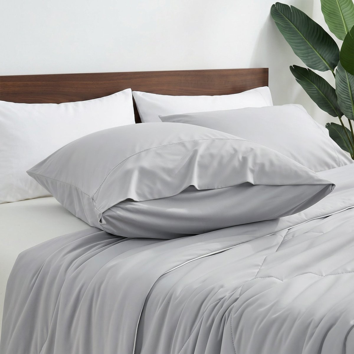Cozy Bliss envelope cooling pillowcases on bed.#color_Light Grey