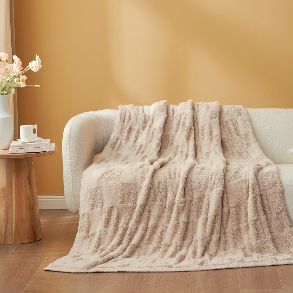 Checkered Faux Fur Feather Yarn Throw Blanket in Beige draped over a sofa, highlighting its neutral tone. #color_Beige