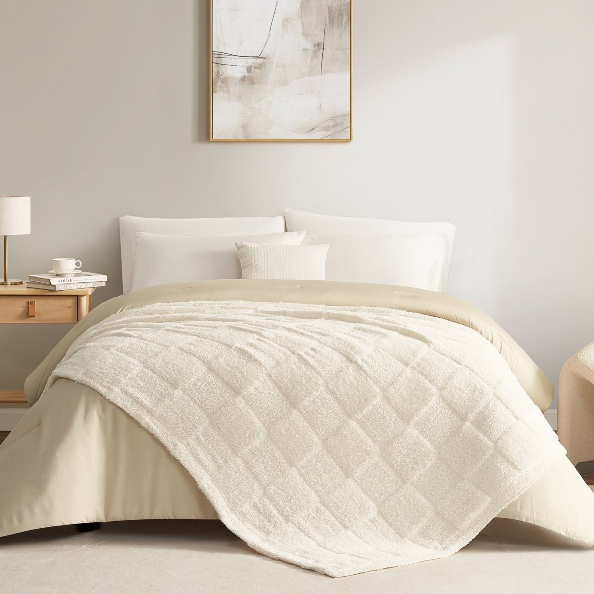 Checkered Faux Fur Feather Yarn Throw Blanket in Ivory styled on a bed, creating a clean and cozy layered look. #color_Ivory