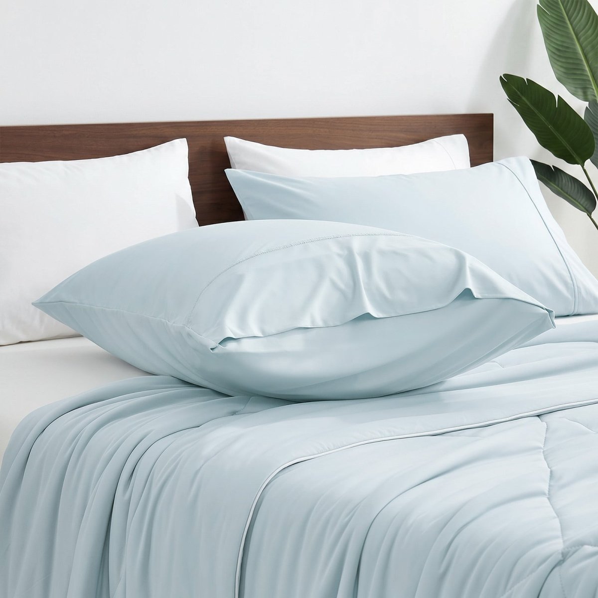 Cozy Bliss envelope cooling pillowcases on bed.#color_Cool Blue
