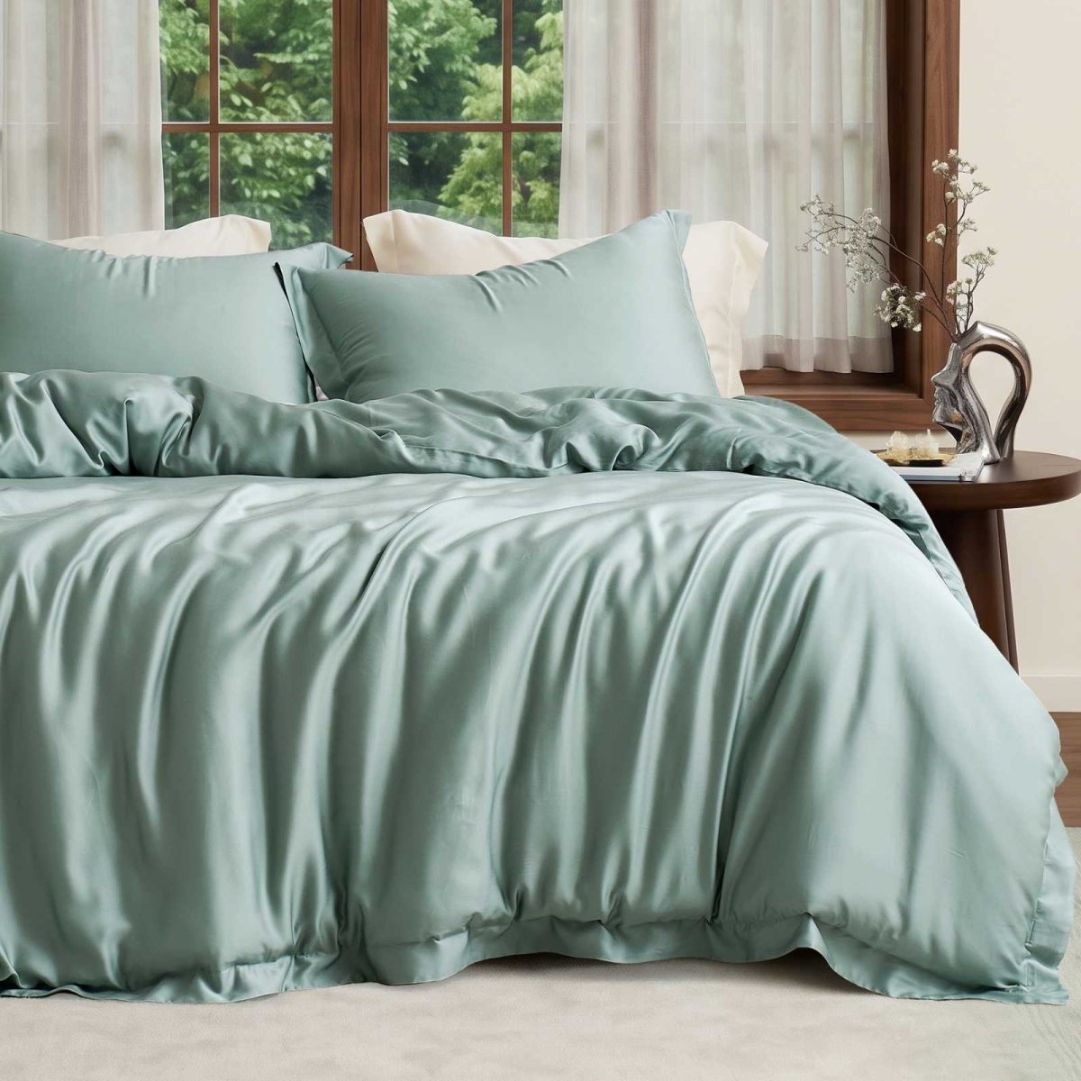 Cozy Bliss Tencel™ Eco-friendly Silky Duvet Cover Set displayed on a bed in a bedroom, showcasing the complete bedding set. #color_Sage Green