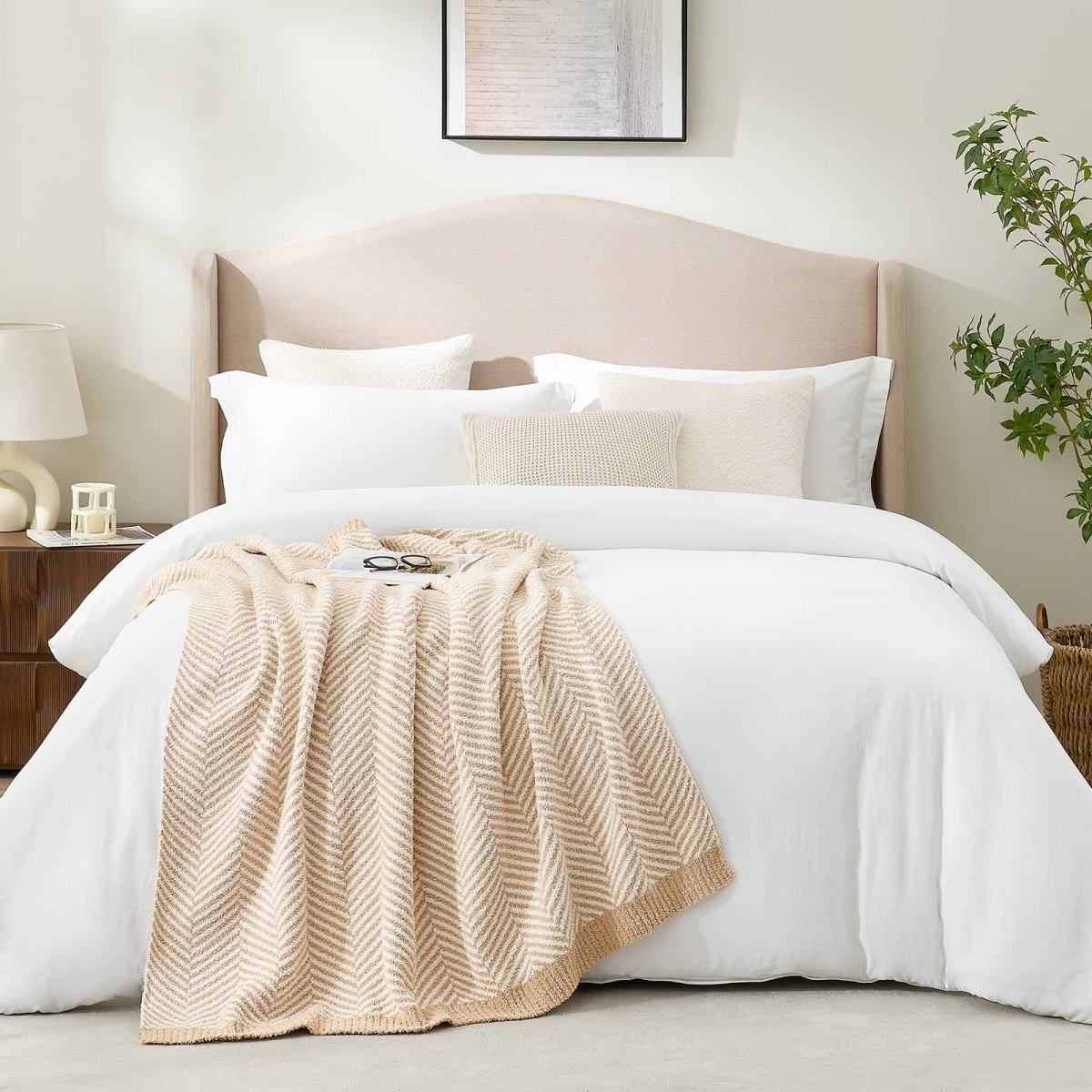 Minimal bedroom styling with Cozy Bliss reversible feather yarn knit throw blanket layered at the foot of the bed #color_Beige