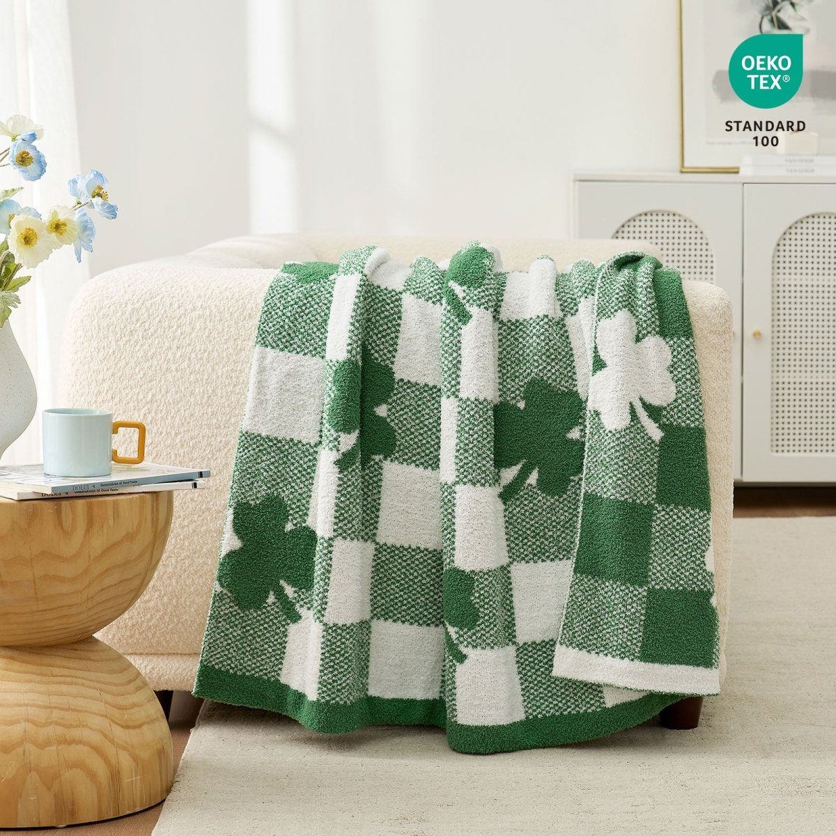 Green and white checkered blanket with shamrock design draped over a chair in a room. #color_Xmas Green