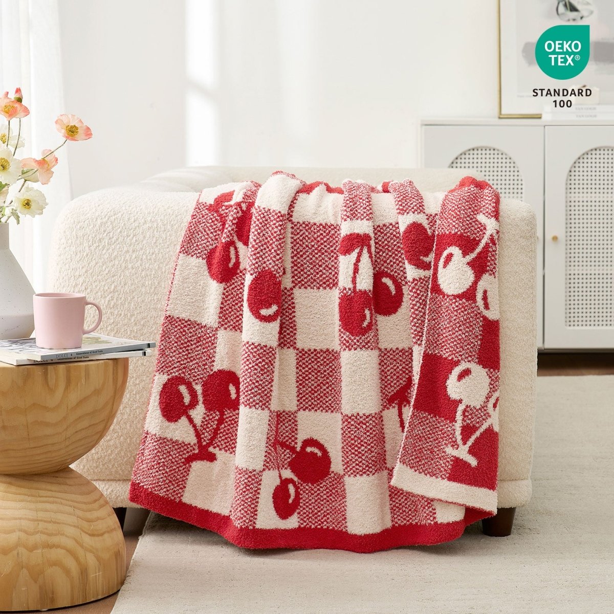 Reversible Checkered With Red Cherry Throw Blanket in Red Cherry draped over a sofa with OEKO-TEX STANDARD 100 certification, highlighting soft and safe fabric quality. #color_Red Cherry