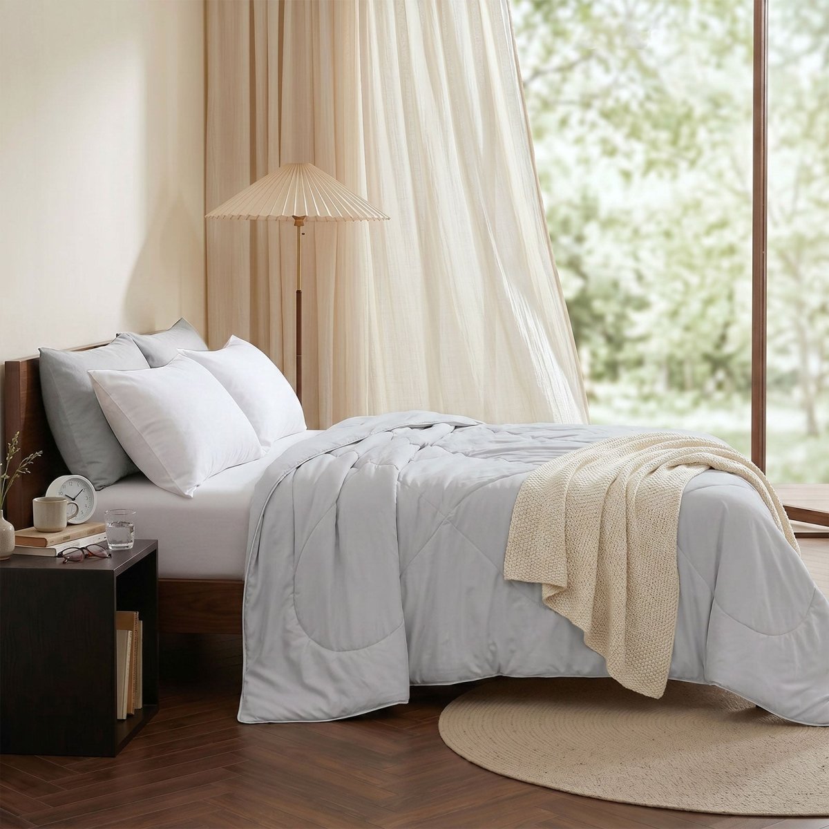 Cozy Bliss cooling comforter on bed in side view. Breathable, soft fabric for hot sleepers. #Color_Light Grey