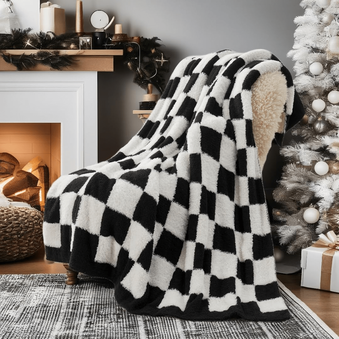 Checkered Faux Fur Feather Yarn Throw Blanket in Black & White draped over a chair, adding a modern stylish touch. #color_Black & White