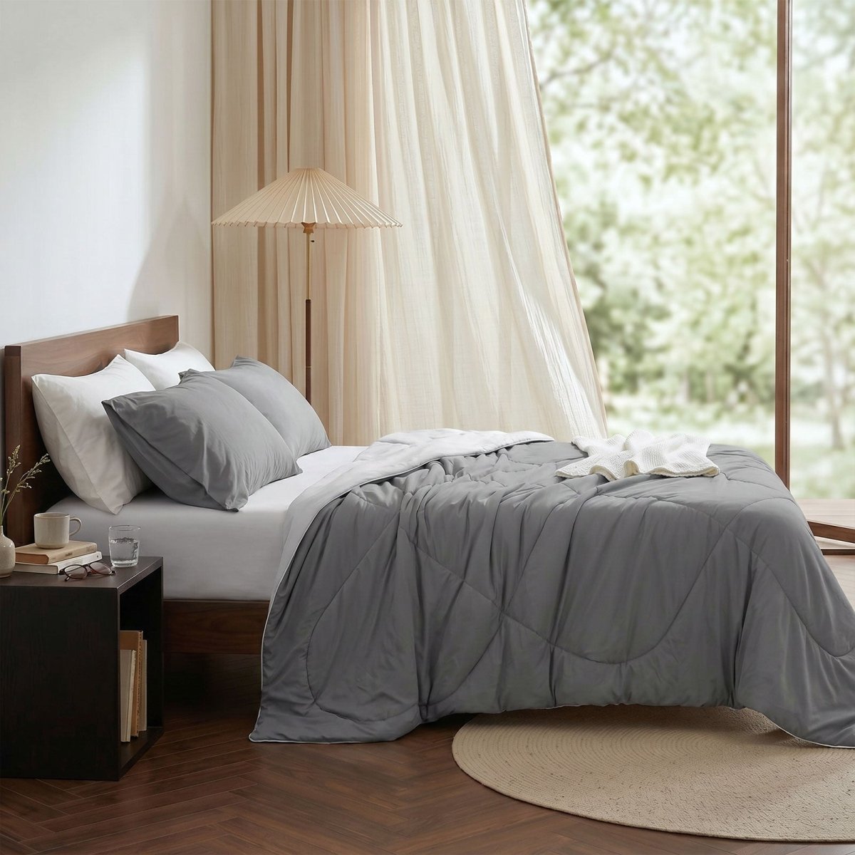 Cozy Bliss cooling comforter on bed in side view. Breathable, soft fabric for hot sleepers. #Color_Dark/Light Grey