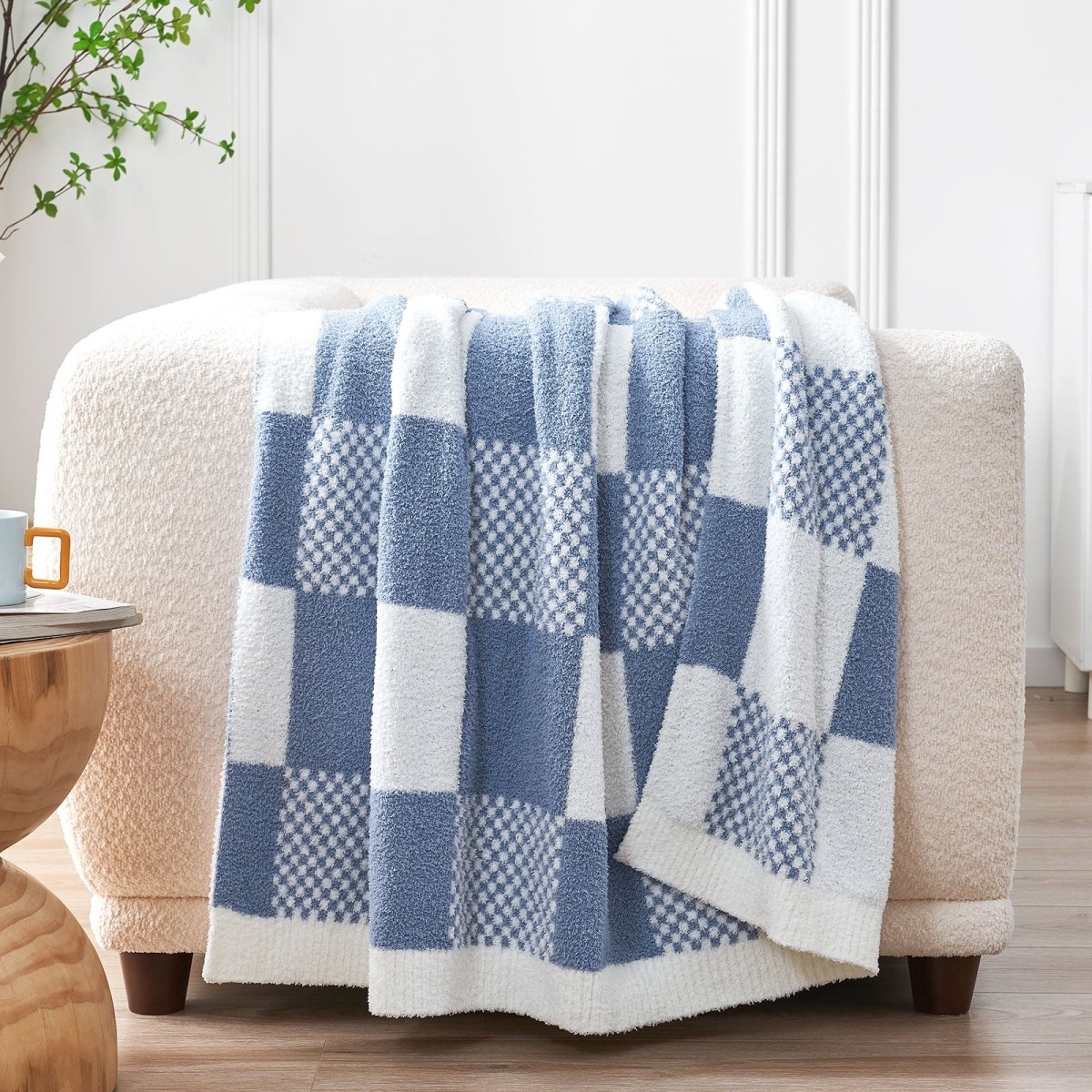 Checkered Feather Yarn Throw Blanket in Dark Blue draped over a sofa, adding warmth and a cozy layered look. #color_Dark Blue