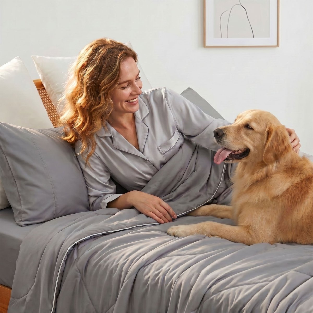 Woman in pajamas and her golden retriever dog lying on Cozy Bliss cooling comforter, showing lightweight bedding perfect for pet owners.#color_Dark Grey