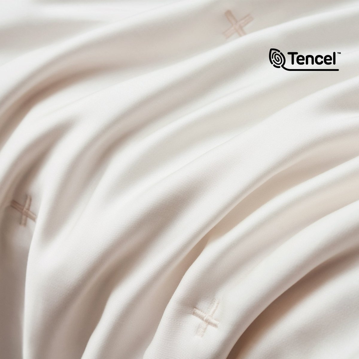 Close up of silky smooth Tencel™ lyocell cooling fabric with OKEO-TEX Standard 100 certification.#color_Off White