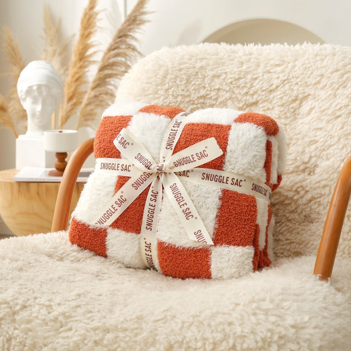 Checkered Faux Fur Feather Yarn Throw Blanket in Orange neatly folded with ribbon, ideal for gifting. #color_Orange