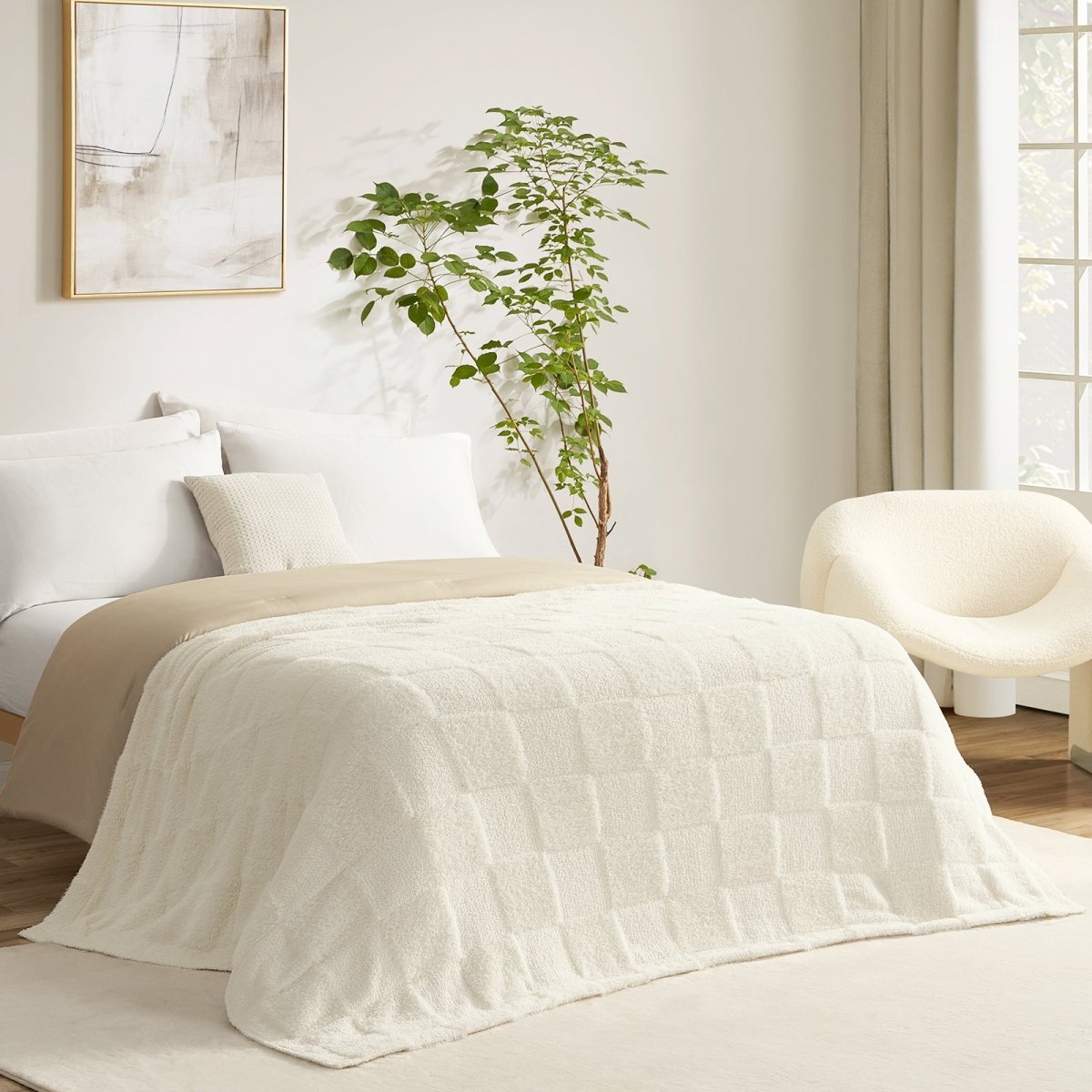 Checkered Faux Fur Feather Yarn Throw Blanket in Ivory styled on a bed, creating a clean and cozy layered look. #color_Ivory
