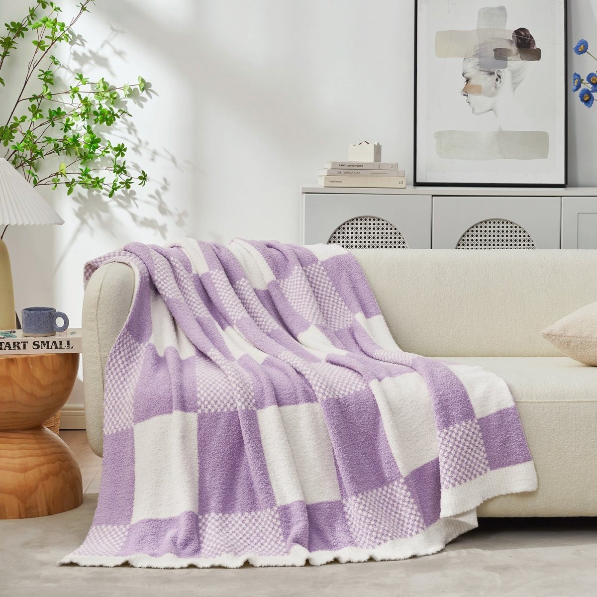 Checkered Feather Yarn Throw Blanket in Lilac draped over a sofa, adding warmth and a cozy layered look. #color_Lilac