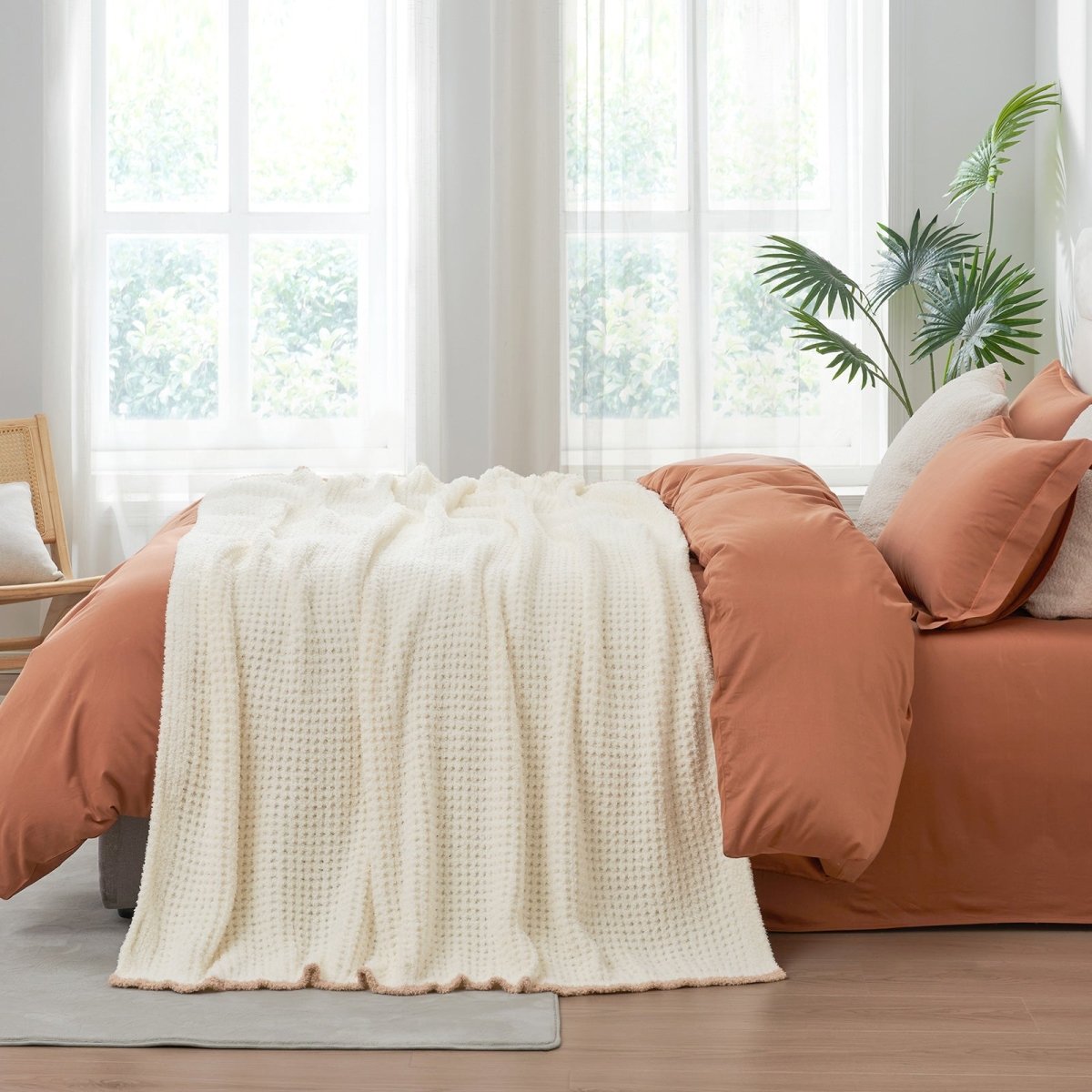 Soft Waffle Feather Yarn Throw Blanket in Cream White styled on a bed, adding a clean and cozy layered look to bedroom decor. #color_Cream White