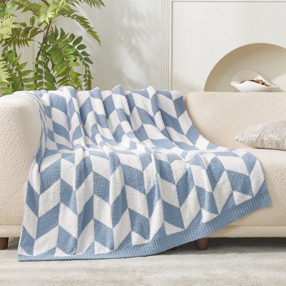 Chevron Feather Yarn Knit Throw Blanket in Blue draped across a sofa, highlighting full pattern coverage and cozy fabric texture. #color_Blue