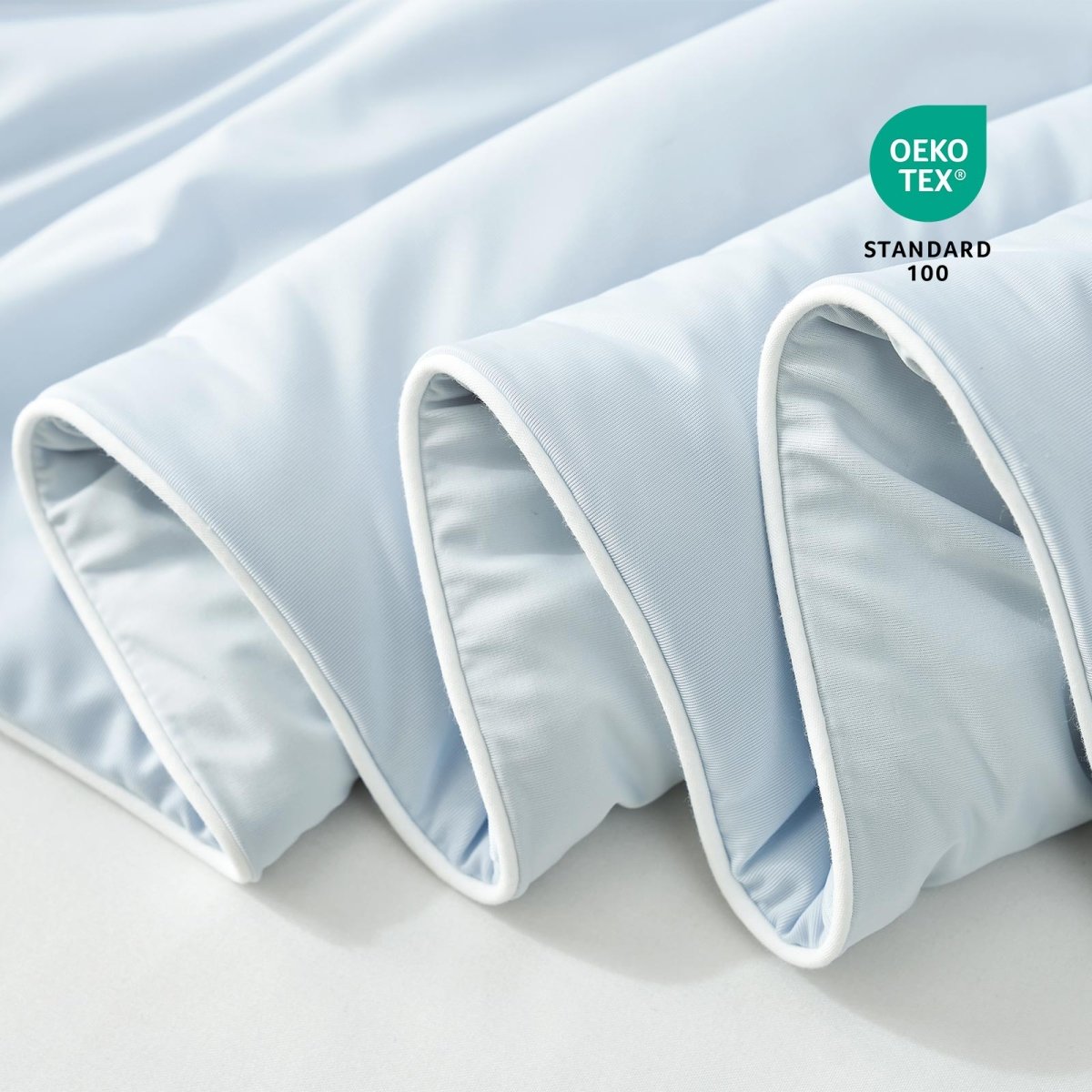 Close-up of blue fabric with Oeko-Tex Standard 100 certification.#color_Cool Blue