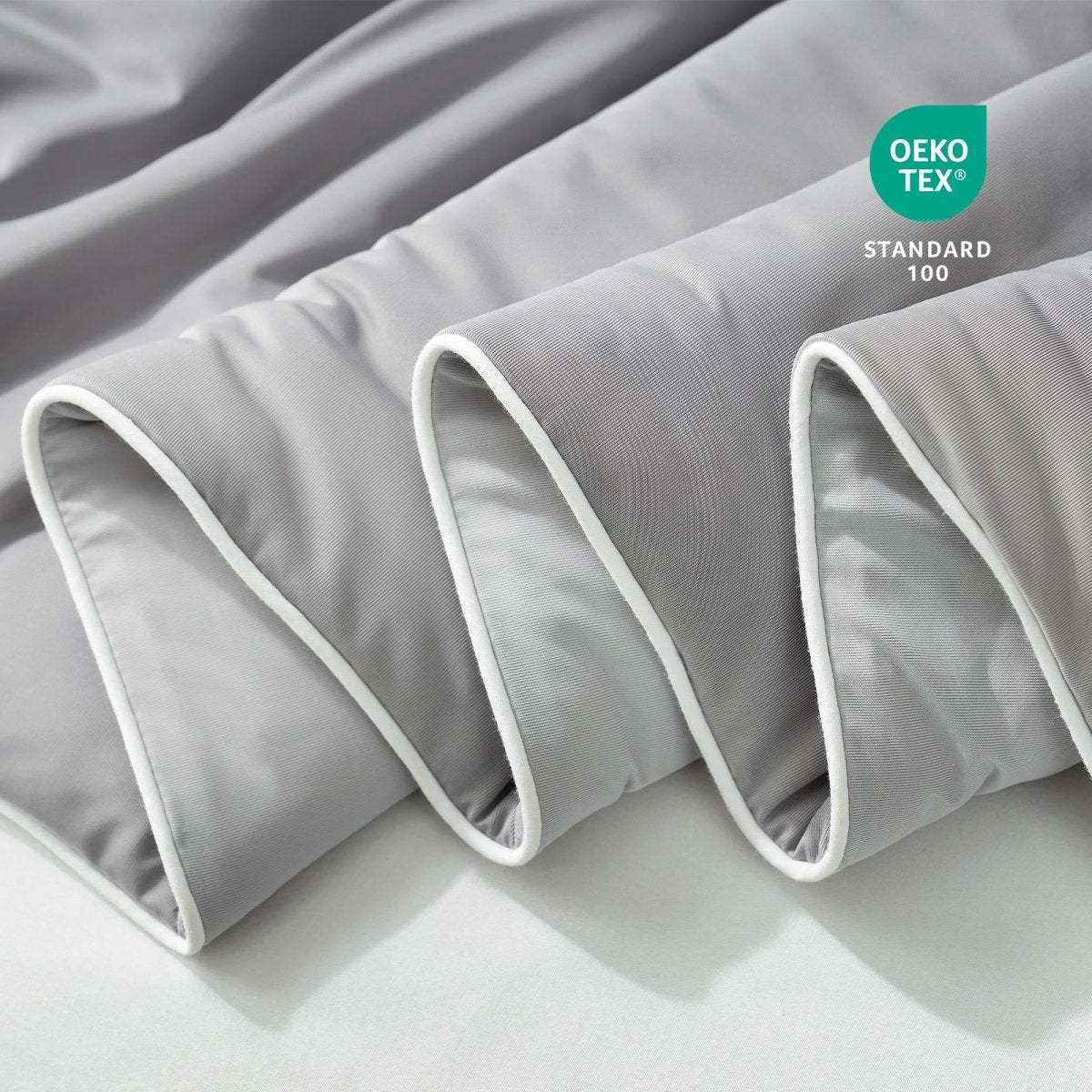 Close-up of grey fabric with Oeko-Tex Standard 100 certification.#color_Cool Grey