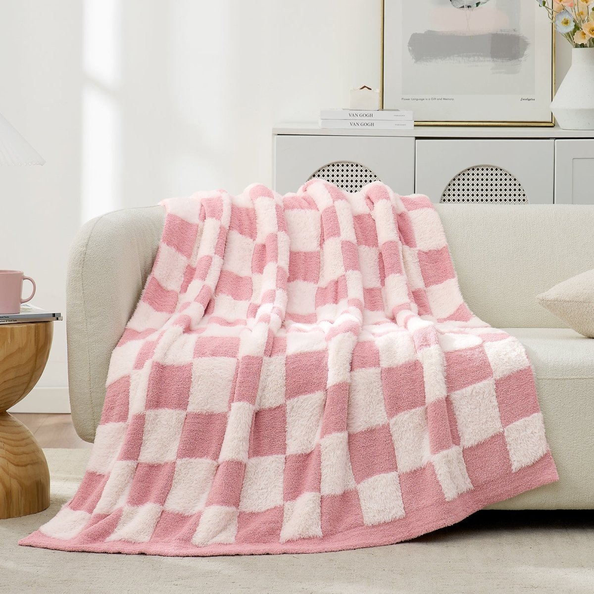 Checkered Faux Fur Feather Yarn Throw Blanket in Pink White draped over a sofa, highlighting its gentle tone and texture. #Color_Pink white