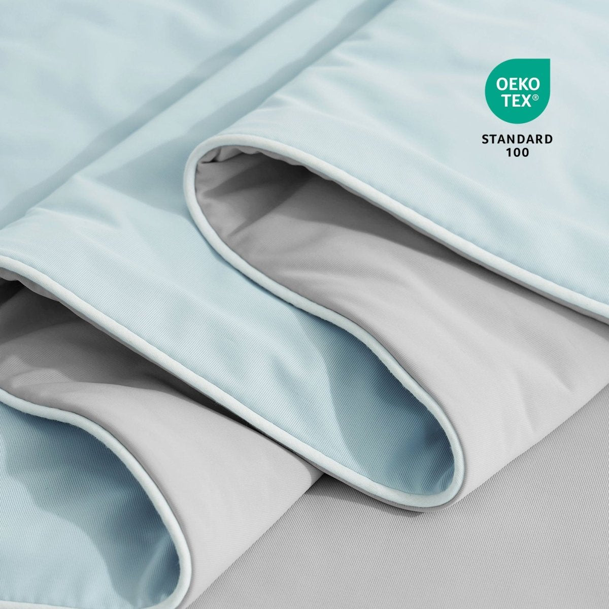 Close-up of OEKO-TEX certified cooling comforter fabric. #Color_Grey/Blue