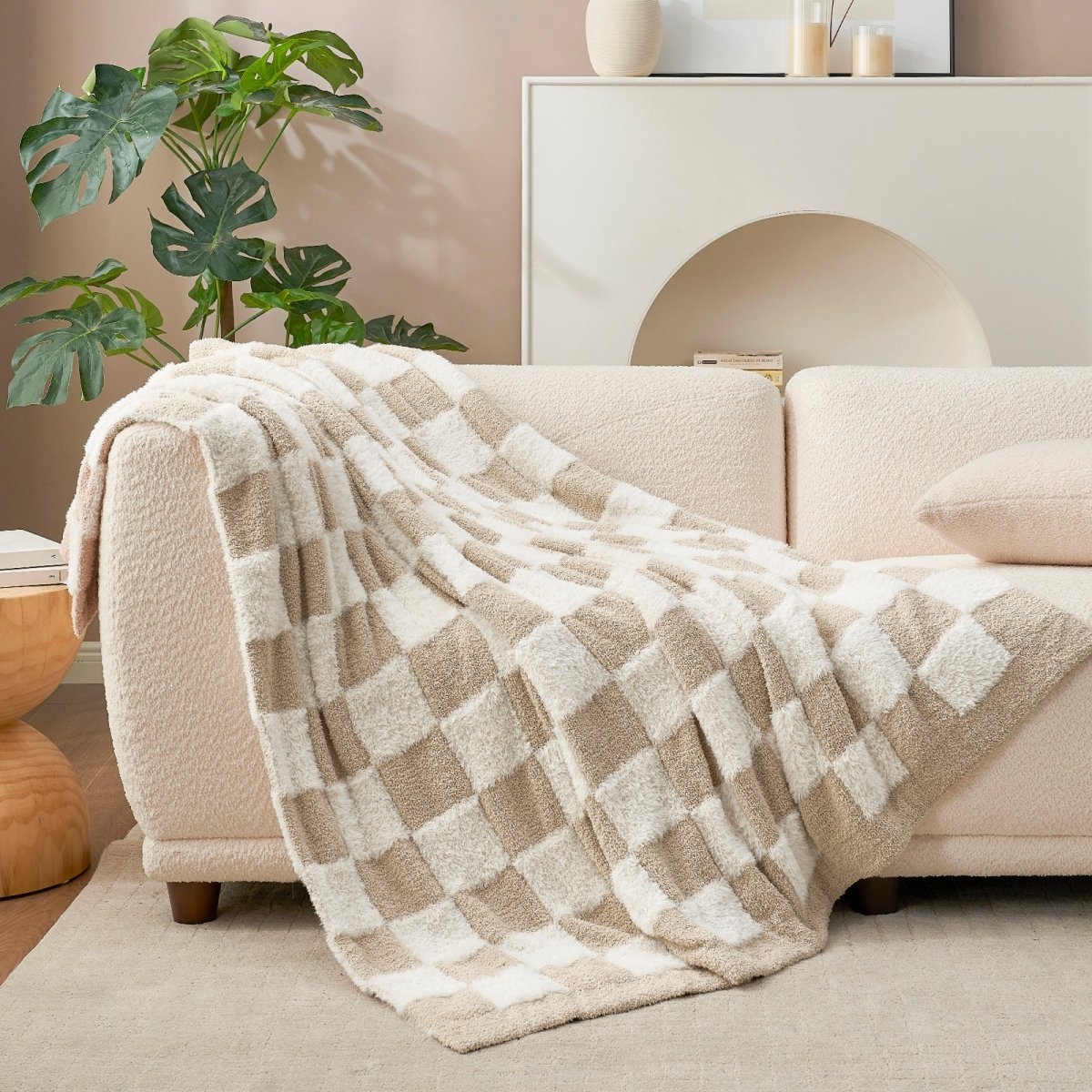 Checkered Faux Fur Feather Yarn Throw Blanket in Beige & White draped over a sofa, highlighting its stylish checkered pattern and soft feel. #color_Beige & White