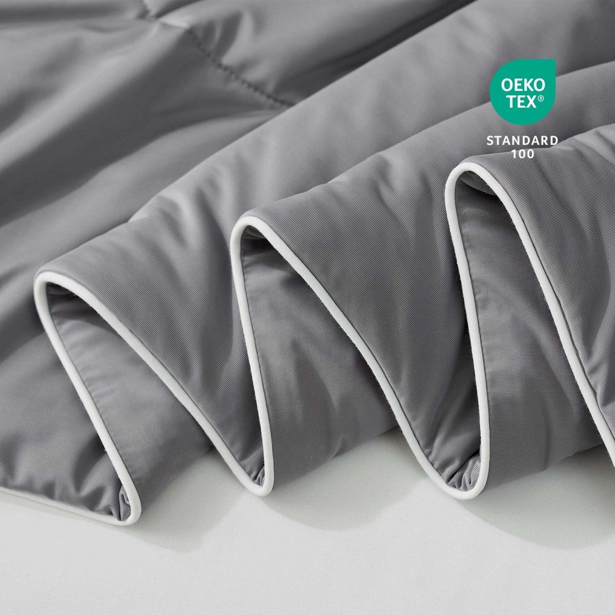 Close-up of grey fabric with Oeko-Tex Standard 100 certification.#color_Dark Grey