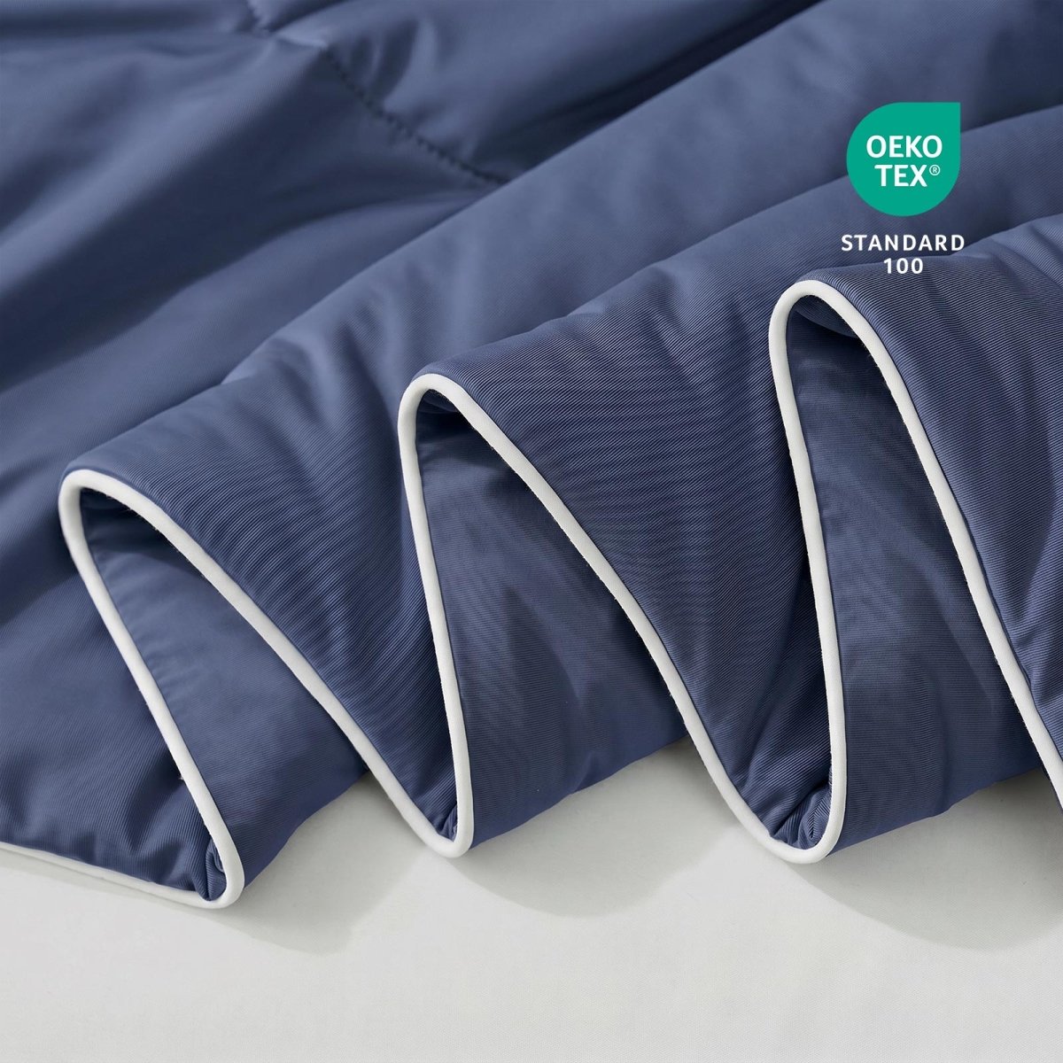Close-up of blue fabric with Oeko-Tex Standard 100 certification.#color_Navy Blue