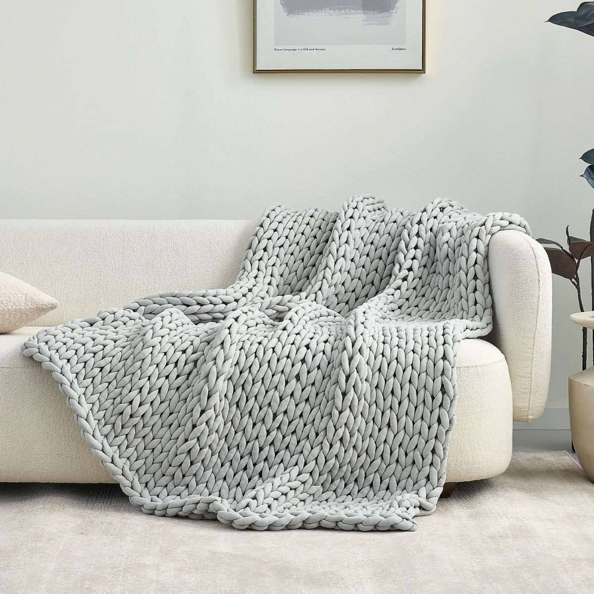 Cozy Bliss Performance Cooling Weighted Blanket chunky knit blanket draped on sofa#color_Light Grey