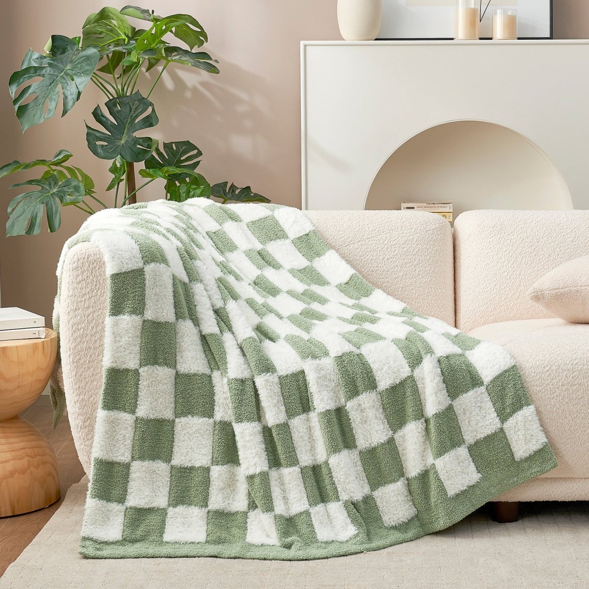 Checkered Faux Fur Feather Yarn Throw Blanket in Sage Green & White draped over a sofa, highlighting its modern pattern. #color_Sage Green & White