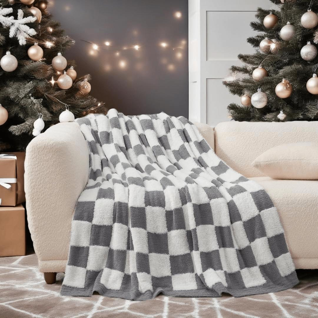 Checkered Faux Fur Feather Yarn Throw Blanket in Grey & White draped over a sofa, highlighting its stylish design. #color_Grey & White