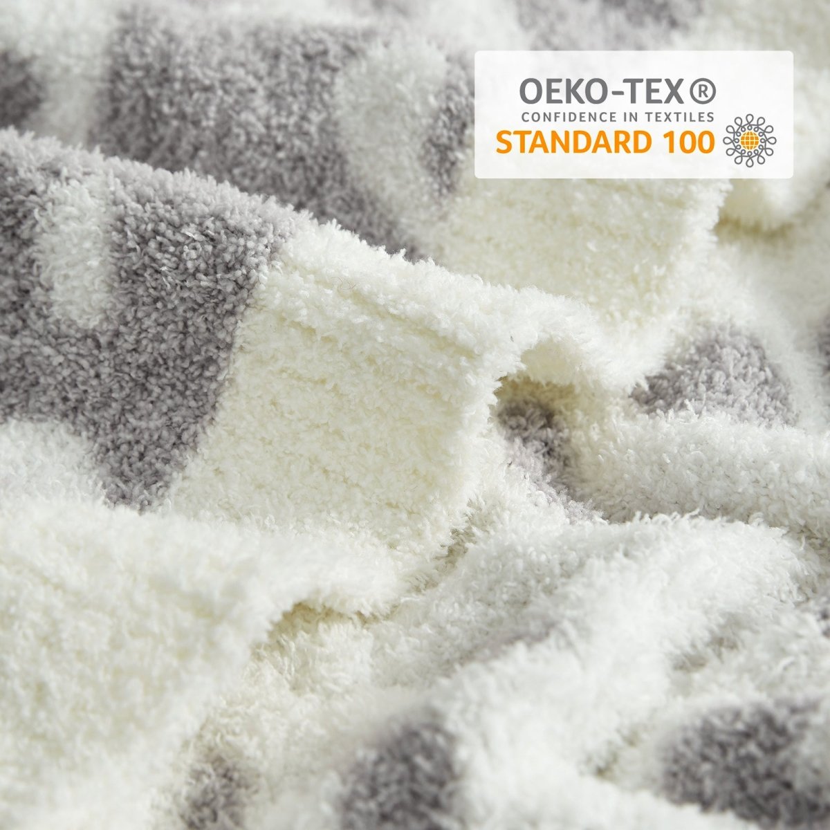 Close-up of Reversible Leopard Feather Yarn Throw Blanket in Leopard Grey showcasing plush texture and OEKO-TEX STANDARD 100 certification. #color_Leopard Grey