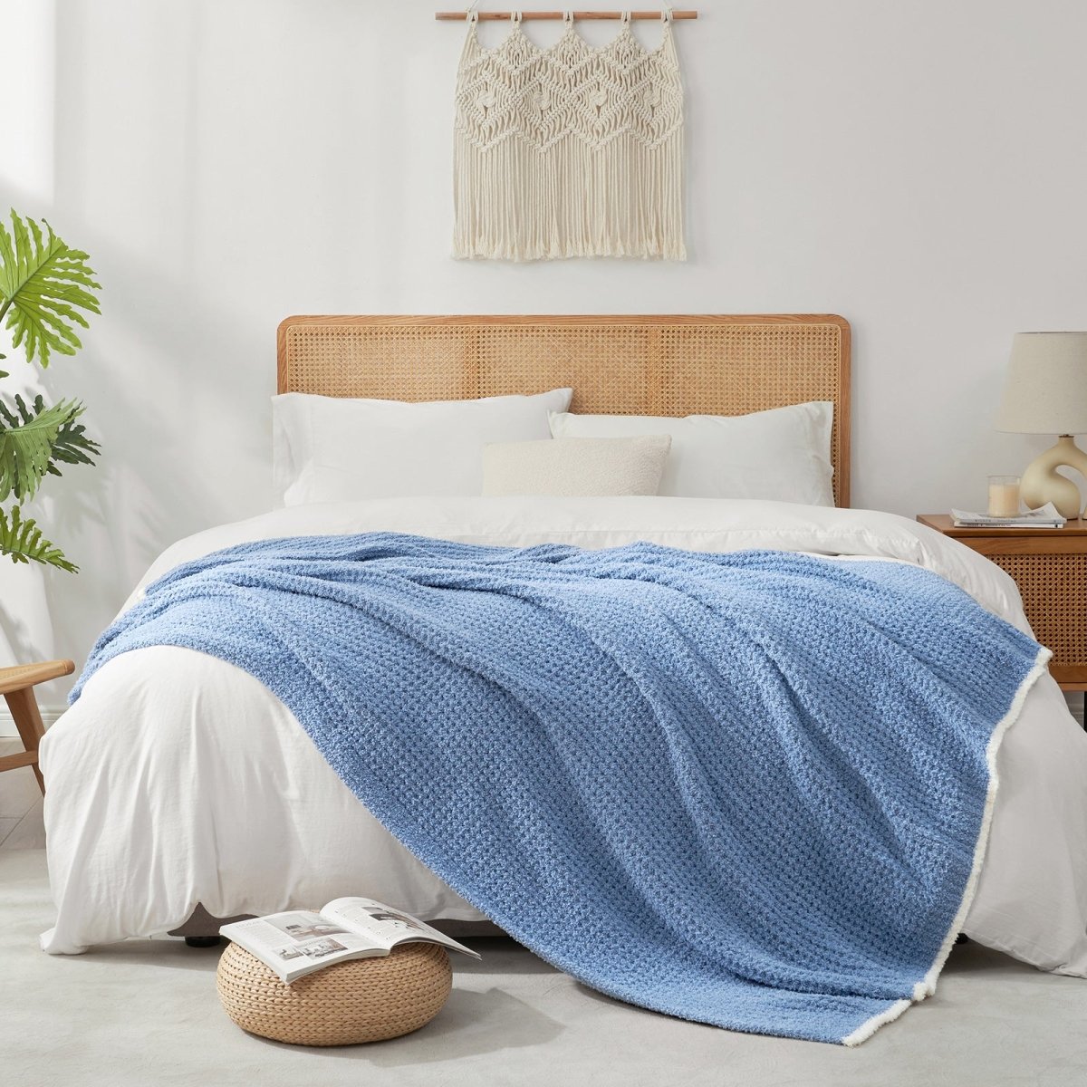 Soft Waffle Feather Yarn Throw Blanket in Dark Blue styled on a bed, adding a modern and cozy layered look. #color_Dark Blue