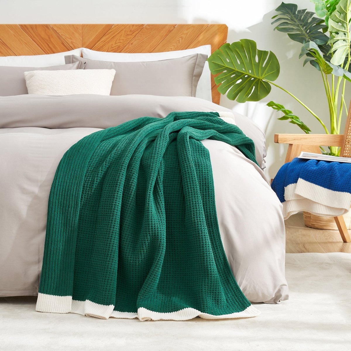Chenille Waffle Knit Throw Blanket in Green styled on a bed, adding a fresh cozy touch. #color_Green