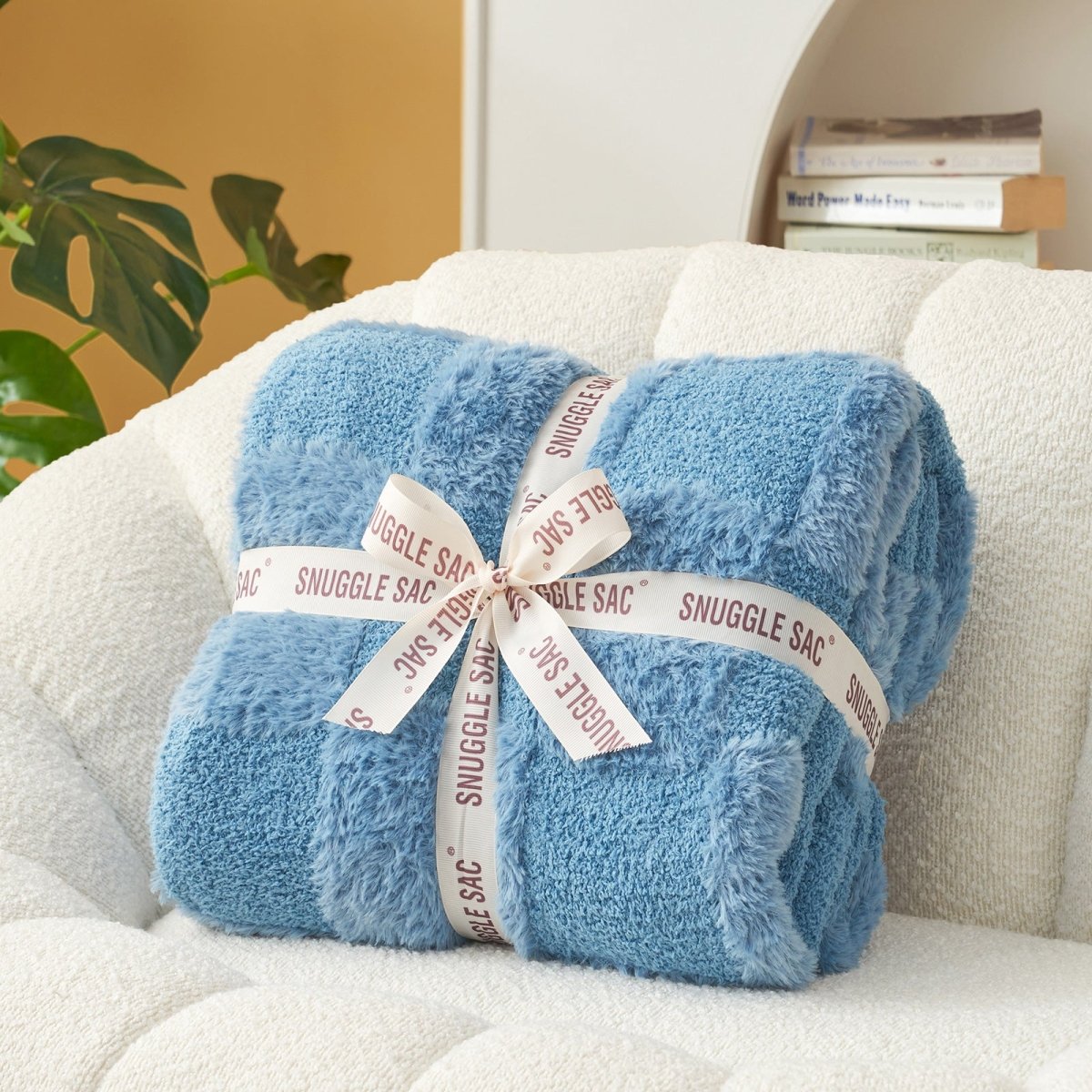 Checkered Faux Fur Feather Yarn Throw Blanket in Blue neatly folded with ribbon, ideal for gifting. #color_Misty Blue