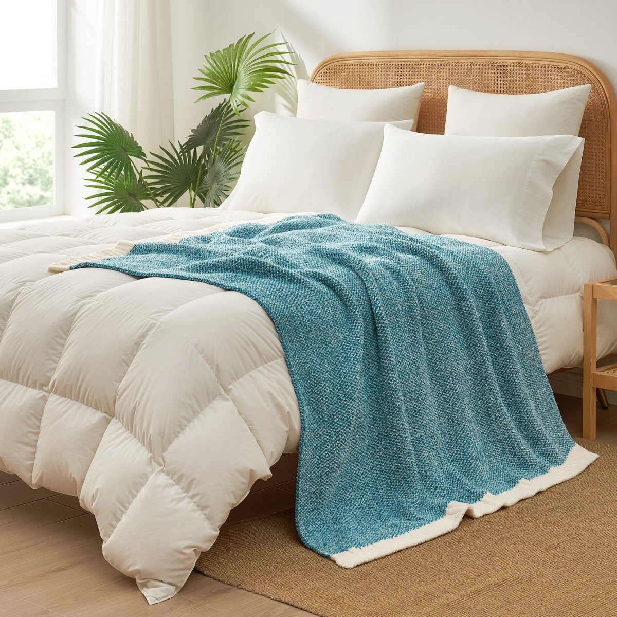 Heather Feather Yarn Throw Blanket in heather teal styled on a bed, enhancing bedroom decor with a soft, elegant and cozy layered look. #Color_Heather Teal