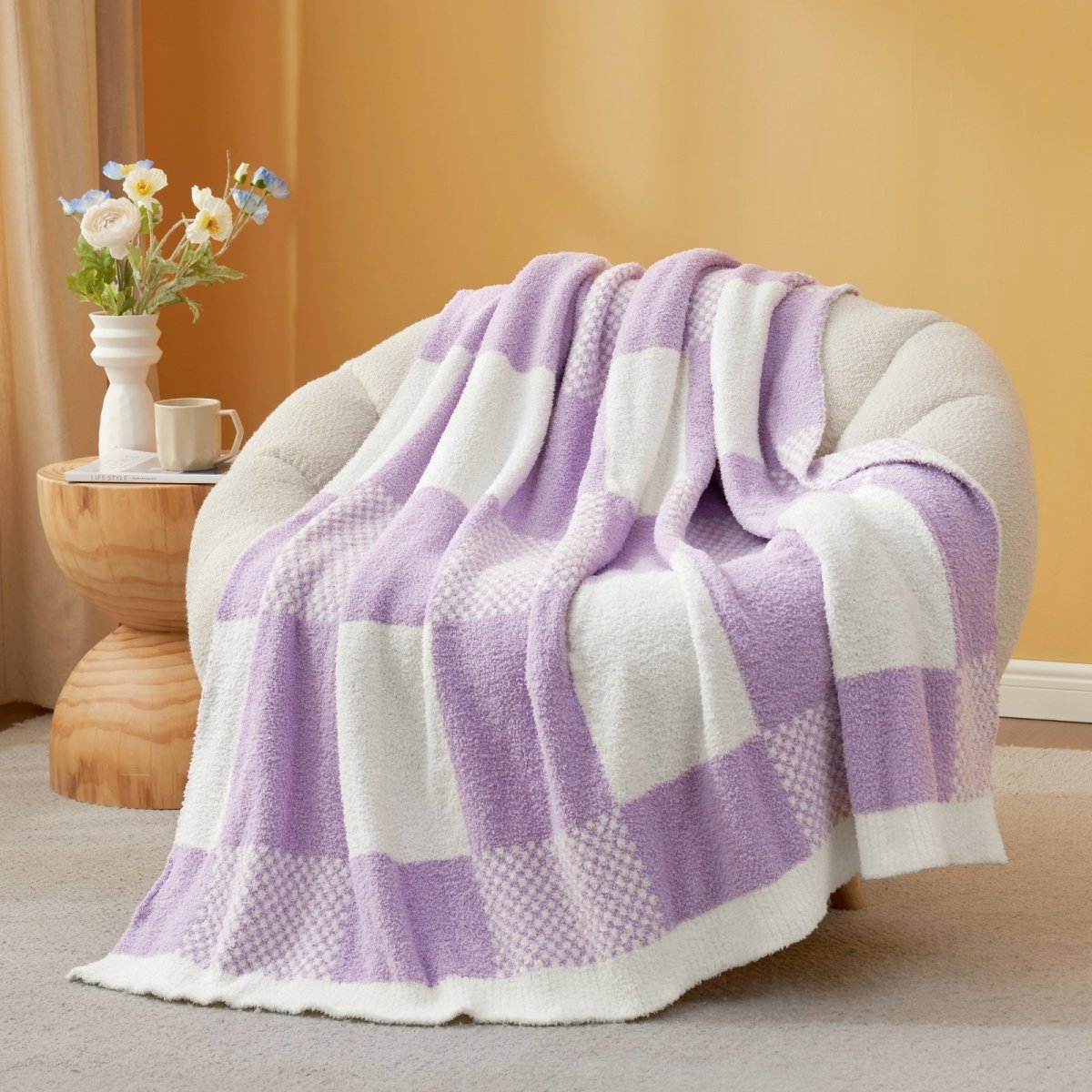 Checkered Feather Yarn Throw Blanket in Lilac front view draped over a chair, showcasing soft feather yarn texture and checkered pattern design. #color_Lilac