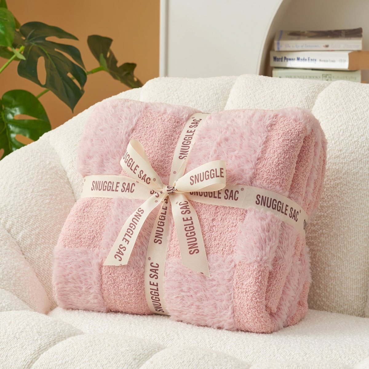 Checkered Faux Fur Feather Yarn Throw Blanket in Pink neatly folded with ribbon, ideal for gifting. #color_Pink