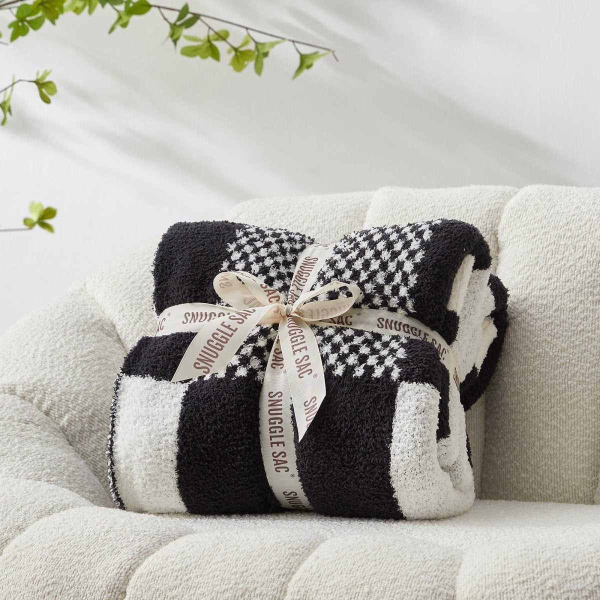 Checkered Feather Yarn Throw Blanket in Black & White neatly folded as gift packaging, perfect for holidays and special occasions. #color_Black & White